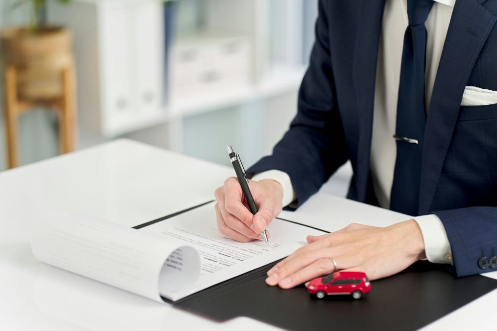Businessman signing a car contract