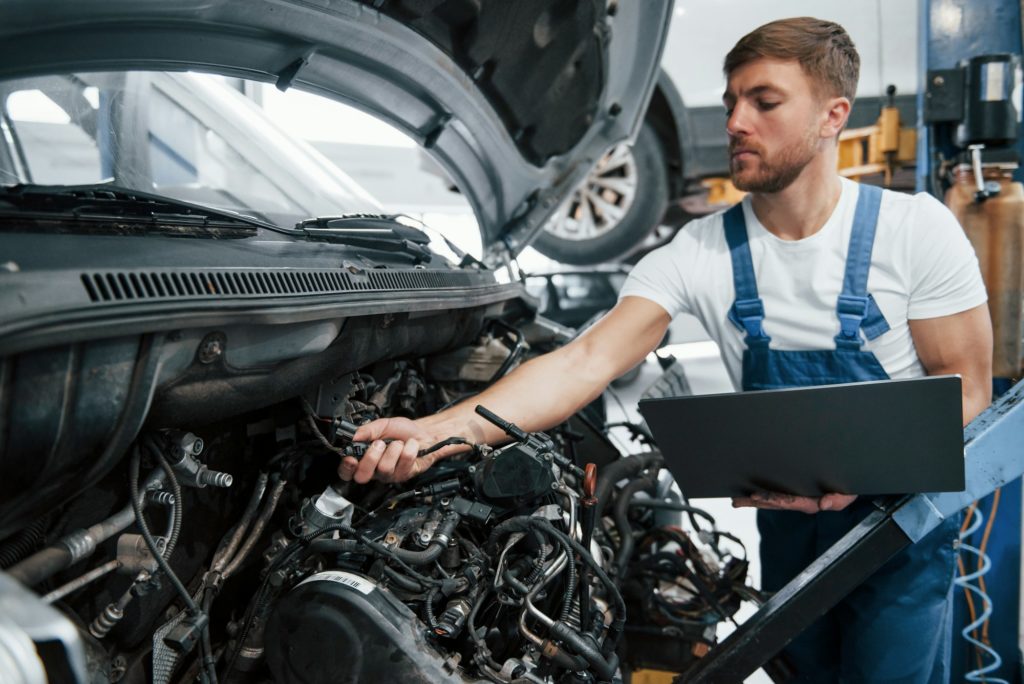 Verifying detail. Employee in the blue colored uniform works in the automobile salon